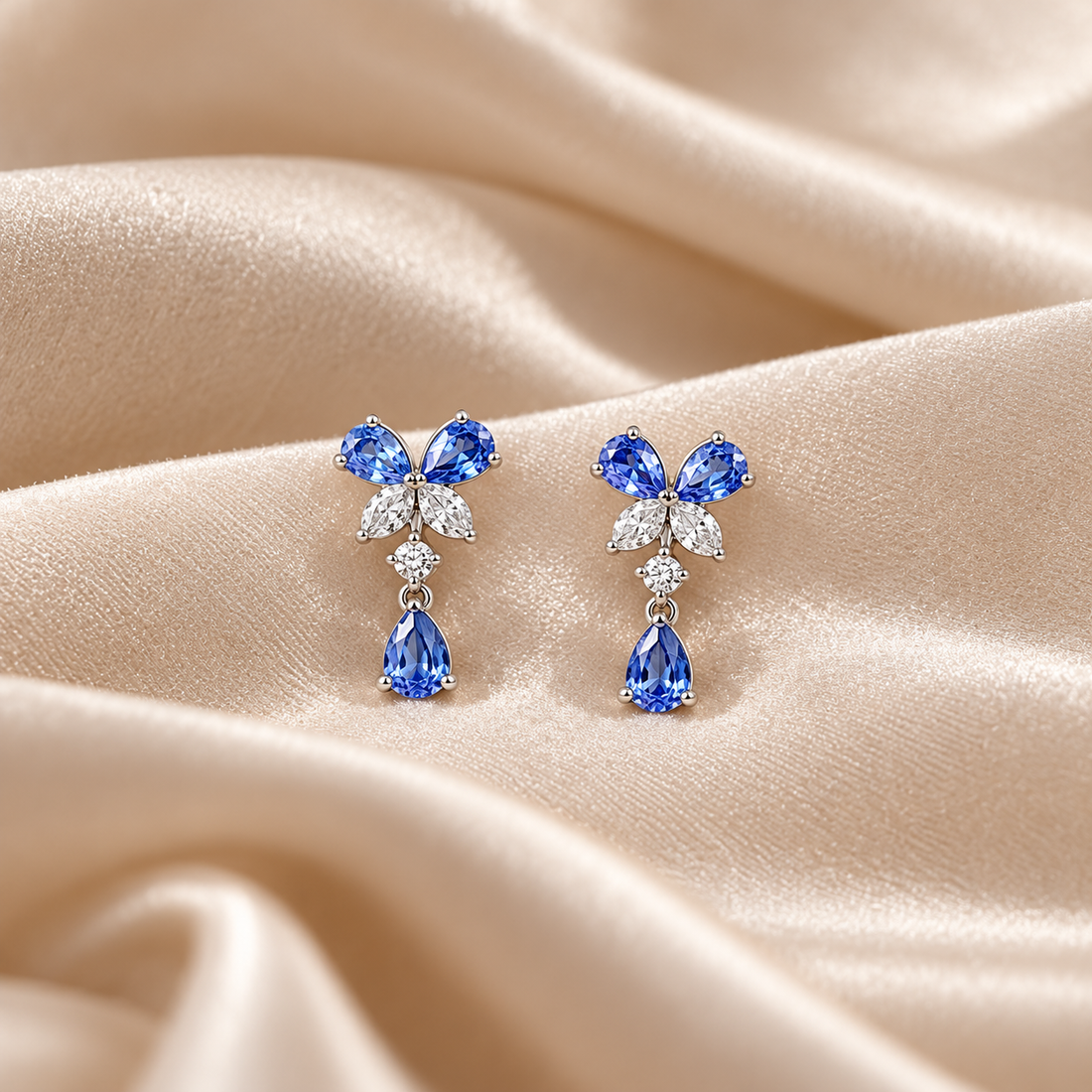 Blue Pear Drop Earrings with Butterfly Stone Cluster