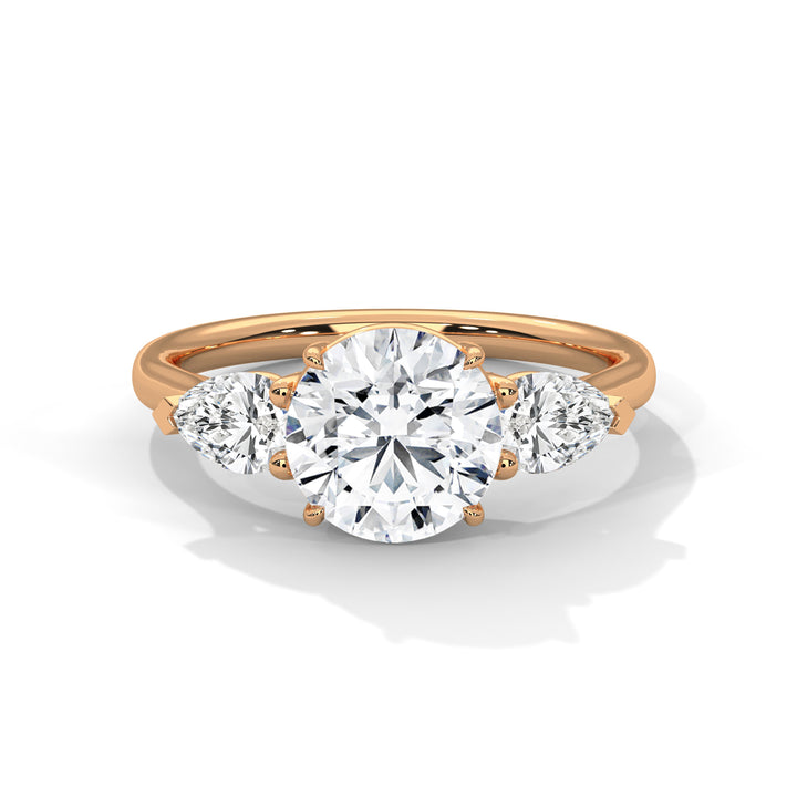 Rose Gold Round Cut Three Stone Pear Side Engagement Ring