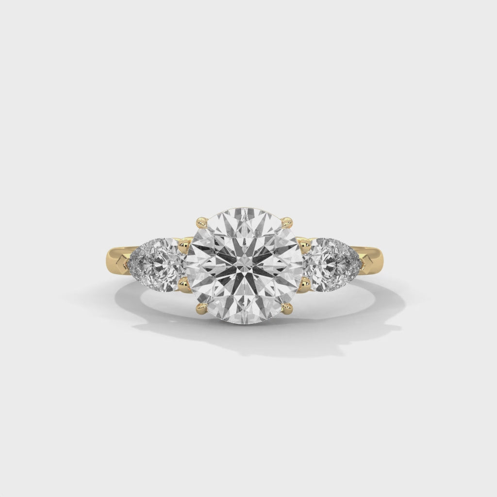 Rose Gold Round Cut Three Stone Pear Side Engagement Ring