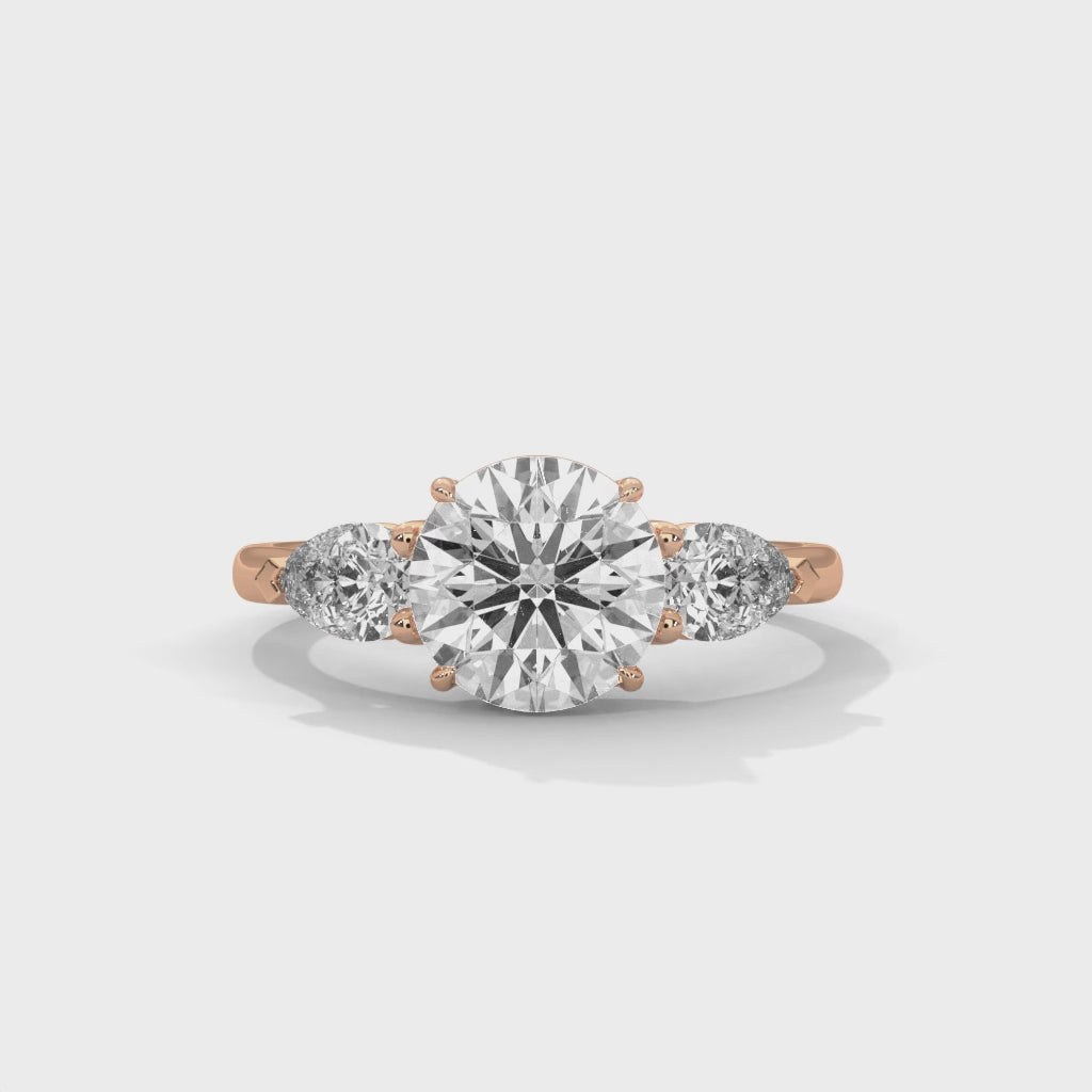 Rose Gold Round Cut Three Stone Pear Side Engagement Ring